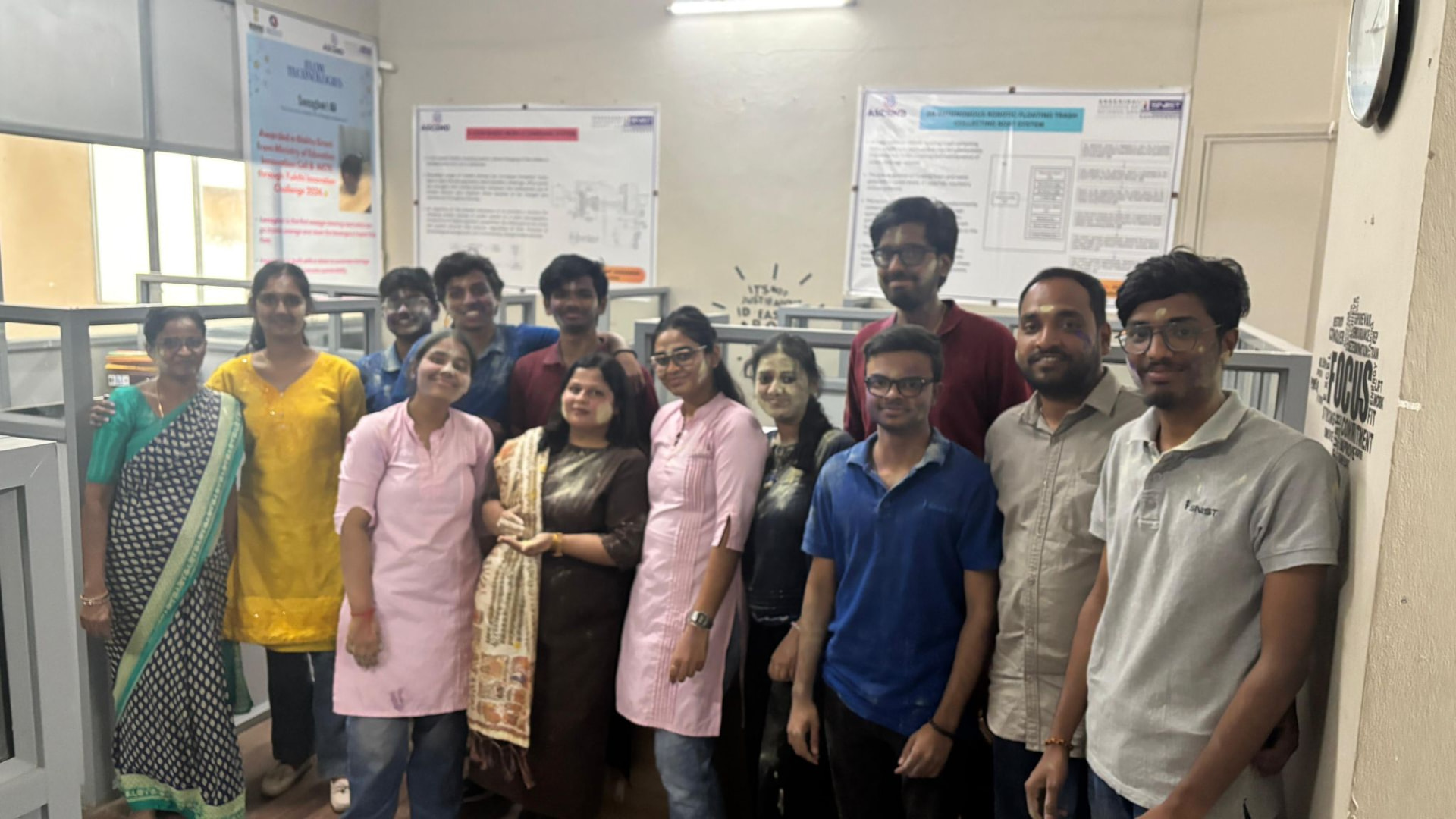 ASCEND team and student innovators at the centre's office beside project posters