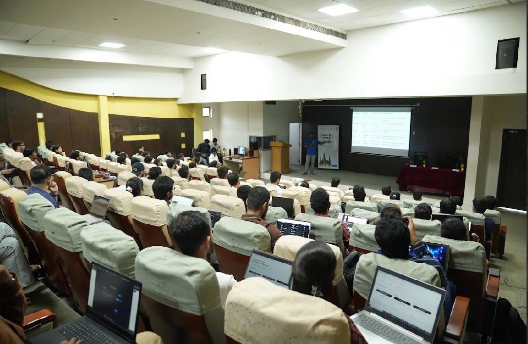 Students coding on laptops during a Build with AI workshop in the auditorium